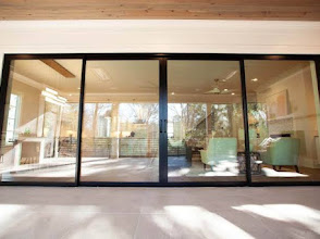 Modern sliding glass doors opening to a pool patio in St. Johns FL