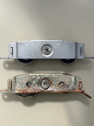 Original vs new sliding door roller comparison