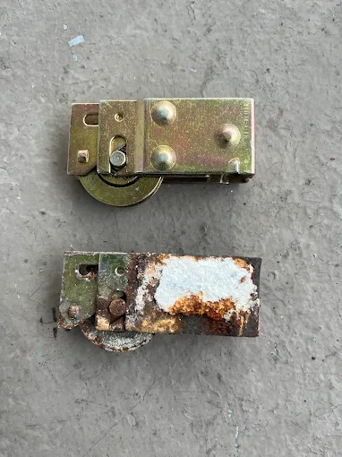 Heavy-duty rollers being installed in a sliding door track